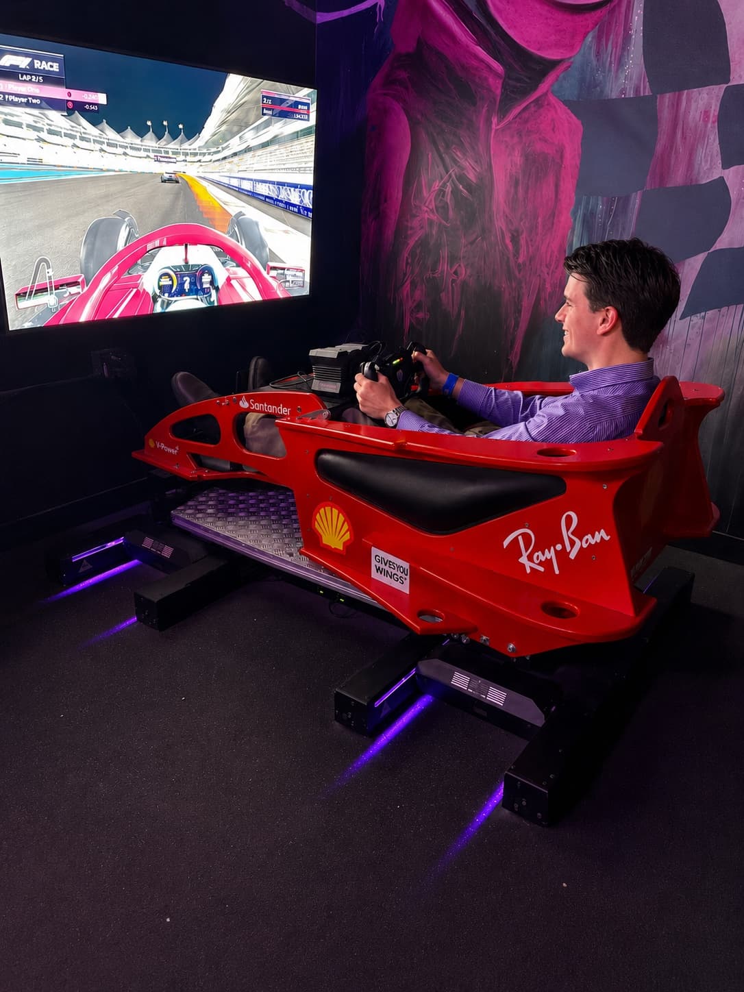 Guest driving the AXED full-motion F1 simulator